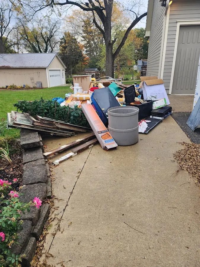 Dumpster being loaded with debris for Estate Cleanout Dumpster Rental in Connell